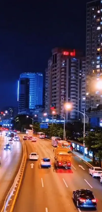 Nighttime cityscape with bright lights and busy traffic under a dark blue sky.