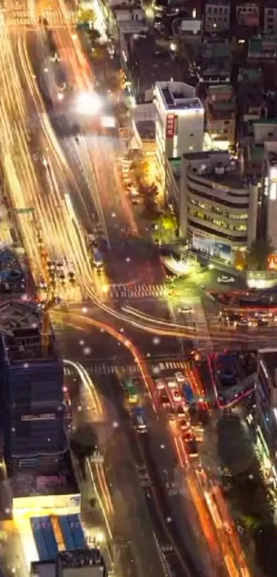 Overhead view of a vibrant city at night with trailing traffic lights.