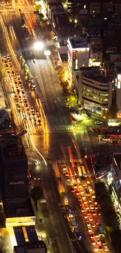 Aerial view of a vibrant city with glowing streetlights at night.