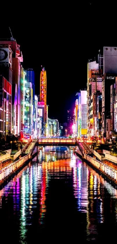 Bright neon-lit cityscape reflecting on water at night.