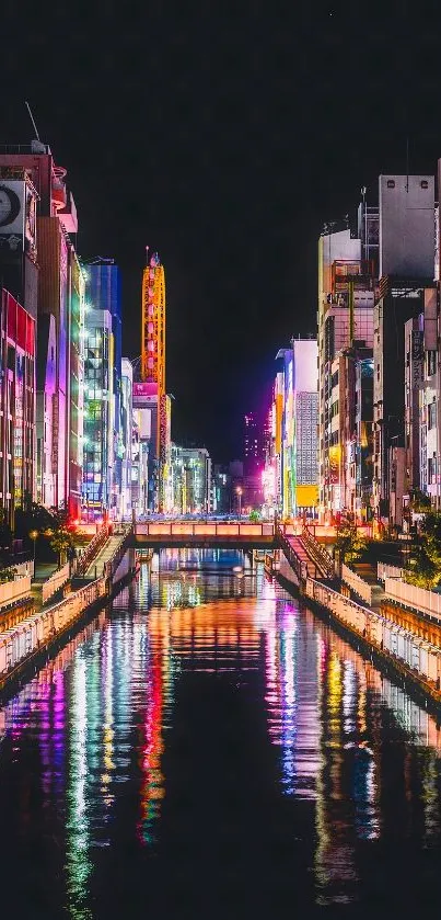 Vibrant city nightscape with colorful reflections on a river.