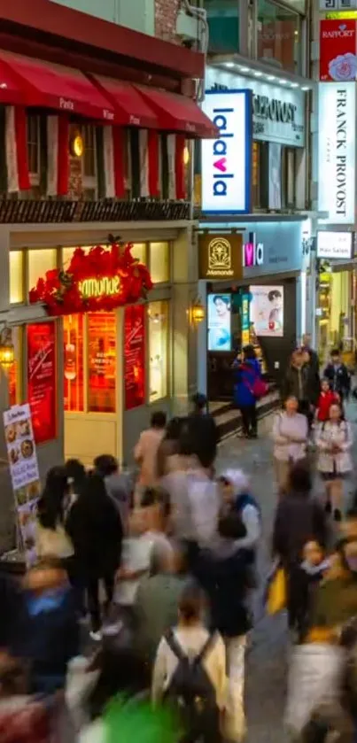 Vibrant city street at night with colorful lights and busy crowd.