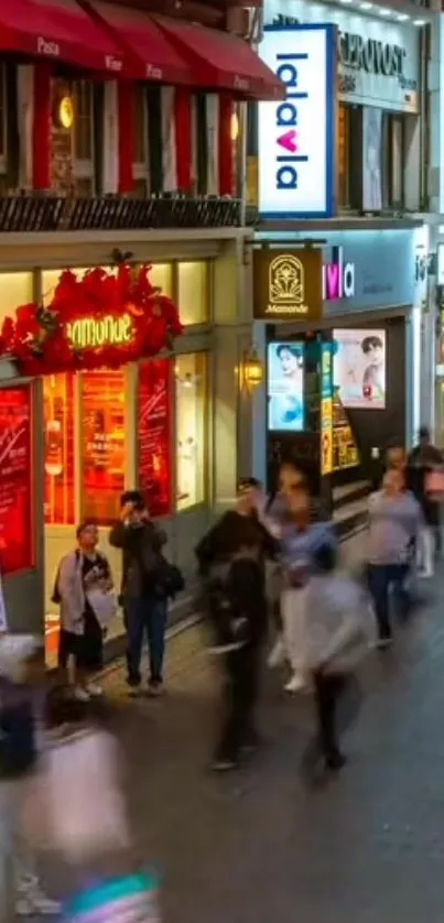 Vibrant city street at night with bright lights and busy people.