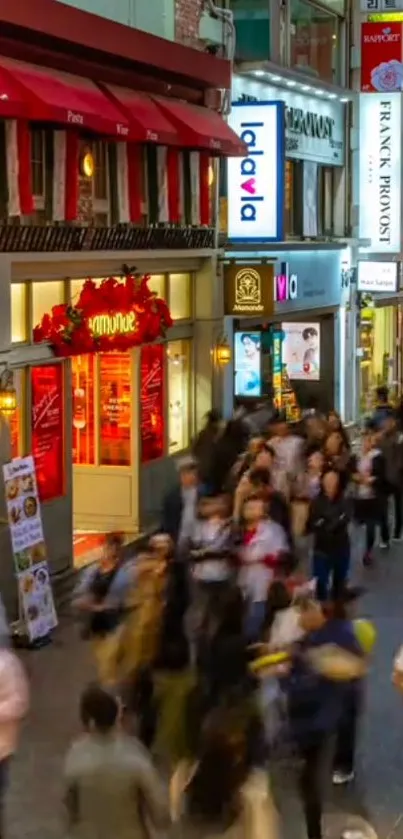 Bustling city street with colorful shops and a lively crowd at night.