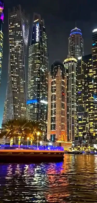 Night cityscape with illuminated skyscrapers and waterfront reflections.
