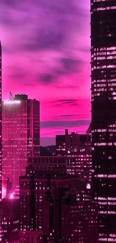 Stunning pink cityscape wallpaper with illuminated buildings at dusk.