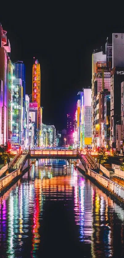 Vibrant cityscape at night with illuminated reflections on a tranquil river.