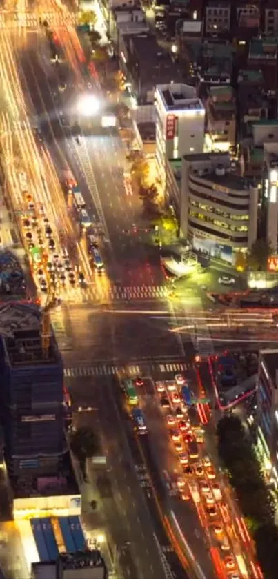 Bird's-eye view of city streets with vibrant night lights and traffic trails.