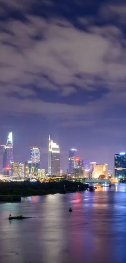 City skyline at night with reflections over water.