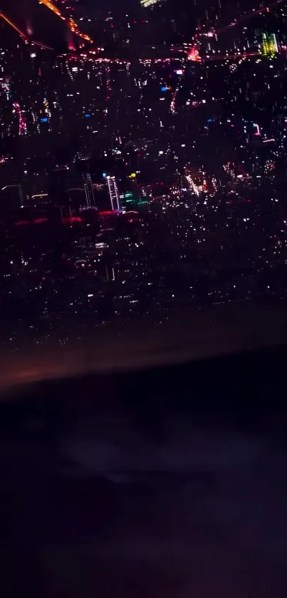 City skyline at night with vibrant lights glowing against a dark sky.