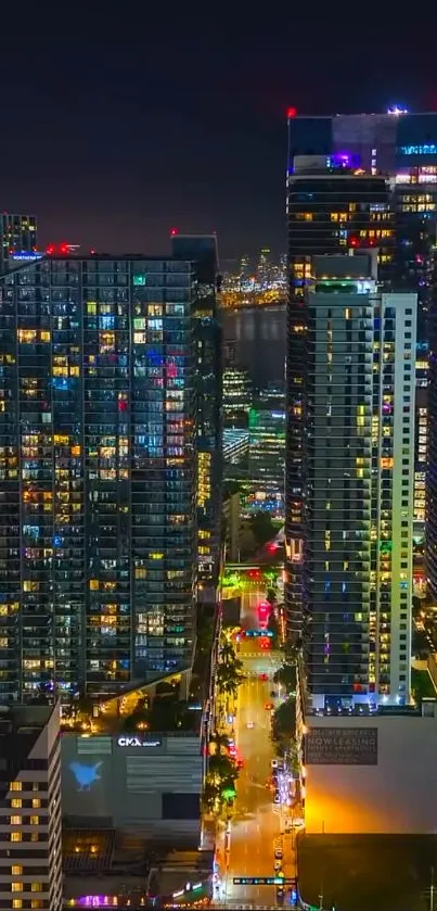 Night view of vibrant cityscape with illuminated skyscrapers.