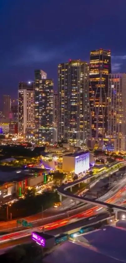 City skyline illuminated at night with bright lights.