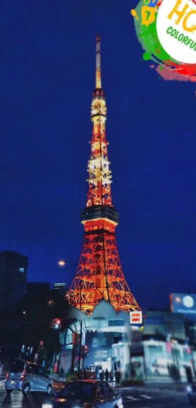 Illuminated tower at night celebrating Holi festival with vibrant colors.