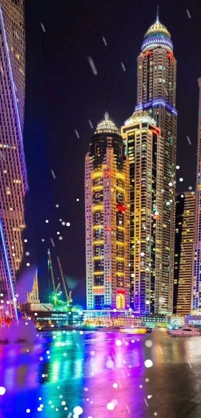 Colorful city skyscrapers reflecting in water at night.