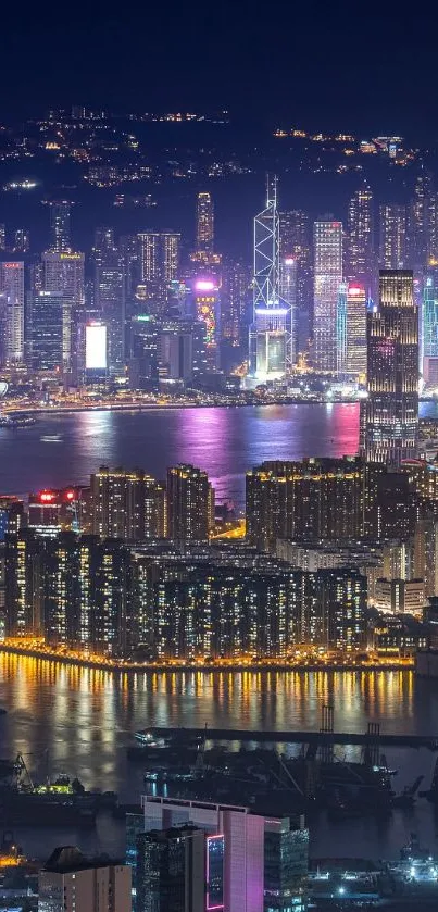 Vibrant city skyline at night with reflections in the water, glowing with lights.