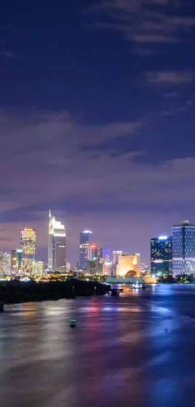 Night view of a vibrant cityscape with illuminated buildings over calm waters.