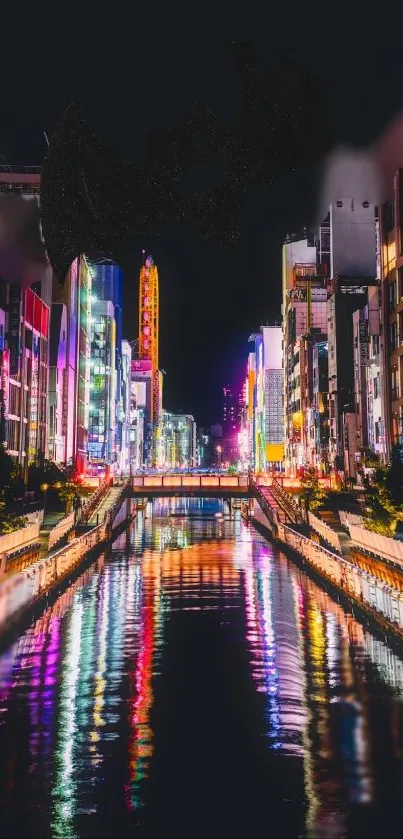 Colorful cityscape at night with vibrant reflections in a water canal.