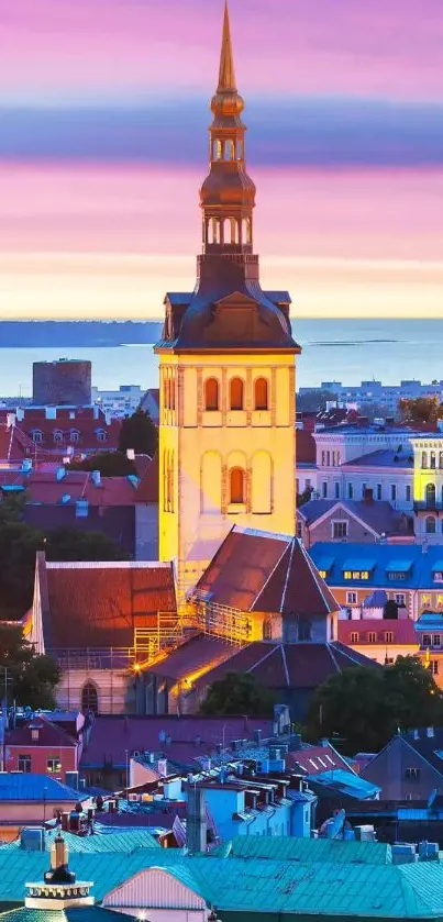 Cityscape with tall spire at colorful sunset.