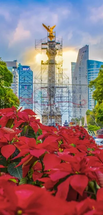 Cityscape with red flowers and monument under blue sky.