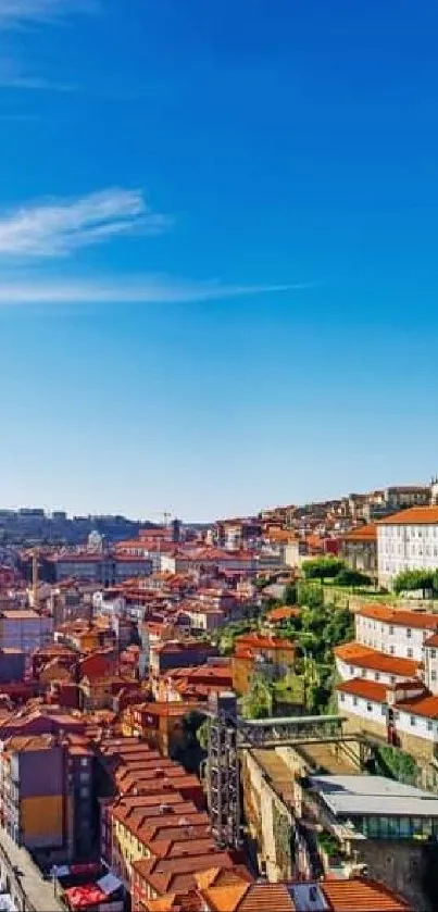 Scenic riverside city with colorful architecture under a clear blue sky.