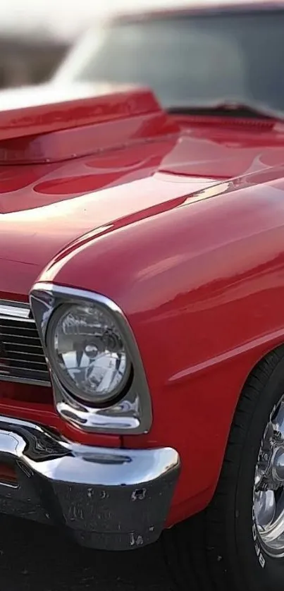 Red classic car with shiny details in focus.