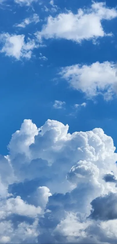 Mobile wallpaper of fluffy white clouds in a vibrant blue sky.