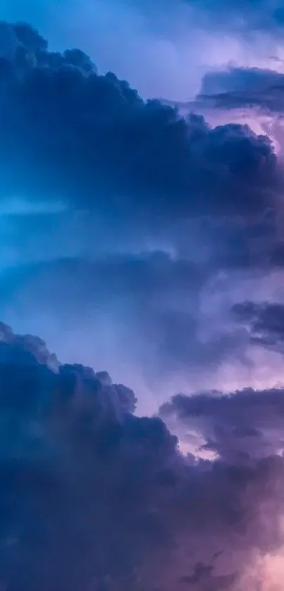 Vibrant wallpaper of a cloudy sky glowing in blue and purple hues.