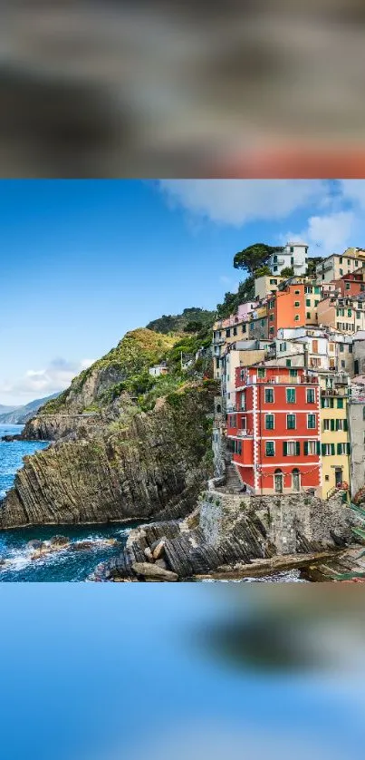 Colorful houses on a coastal cliff by the blue sea.