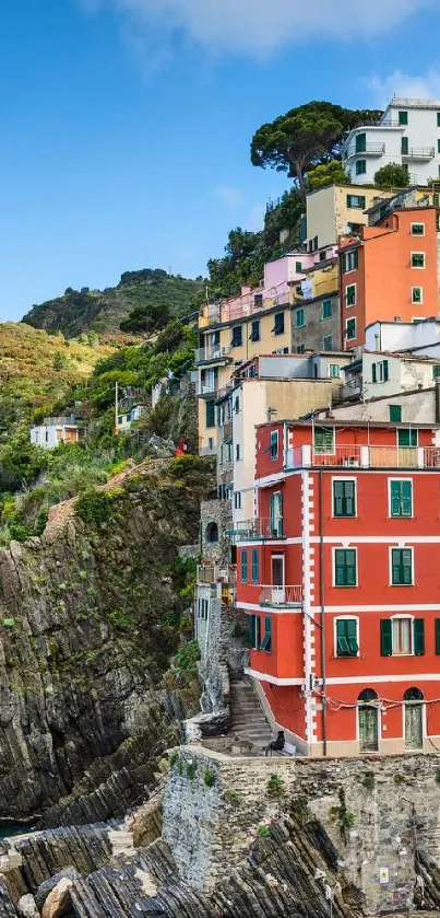 Colorful coastal village perched on cliffs with a vibrant seaside view.
