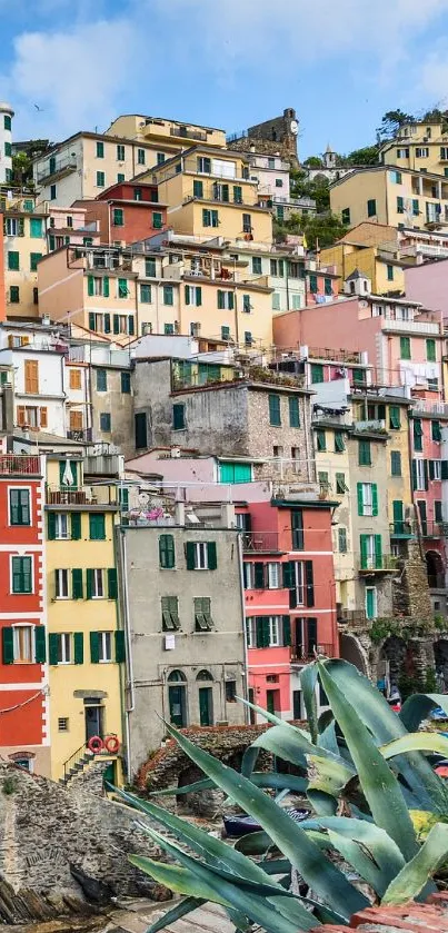 Colorful coastal village on cliffside with ocean view.