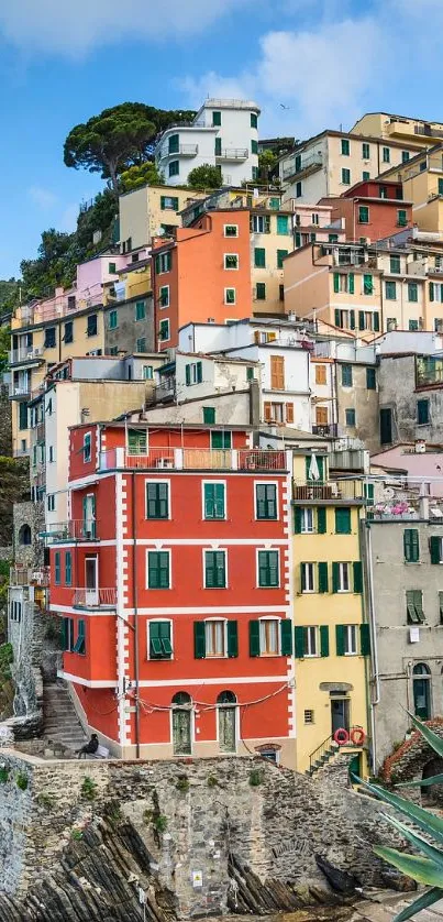 Scenic coastal village with colorful buildings and ocean view wallpaper.