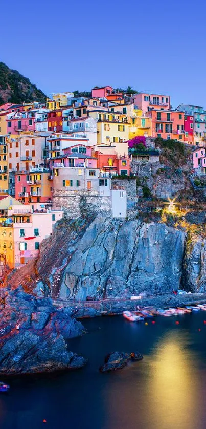 Coastal village with colorful homes perched on cliffs under a clear blue sky.