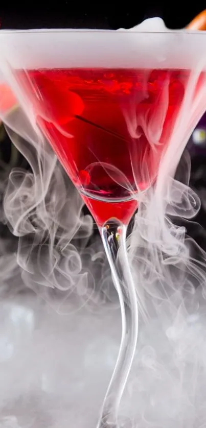 Red cocktail with swirling smoke in glass.