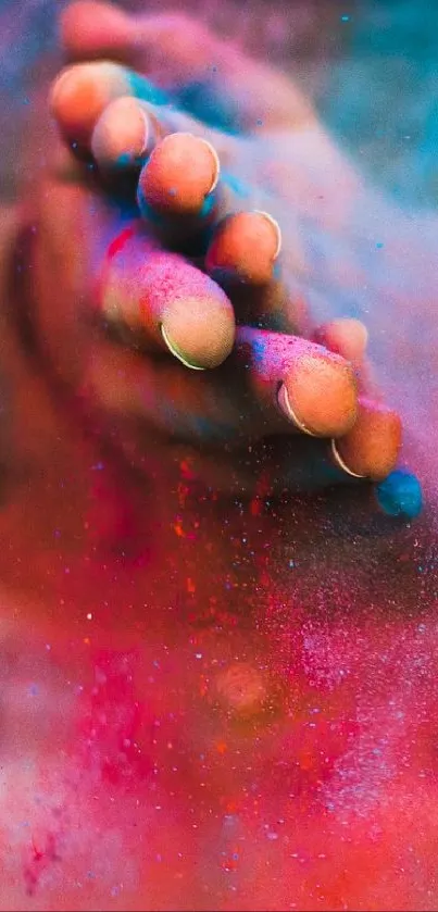 Hands surrounded by vibrant pink and blue color splash.