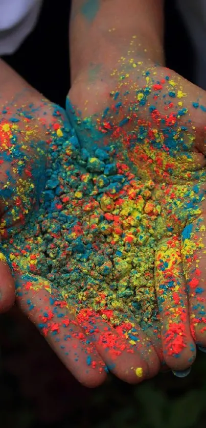 Vibrant colorful powder in hands, artistic wallpaper.