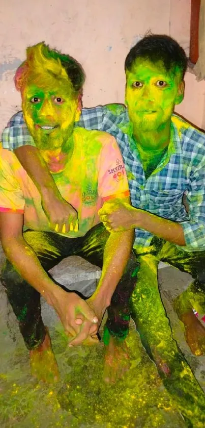 Two people celebrating Holi with vibrant colors and smiles.