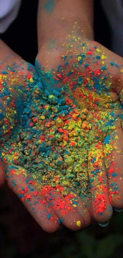 Hands hold vibrant colorful powder, creating artistic and dynamic visual appeal.