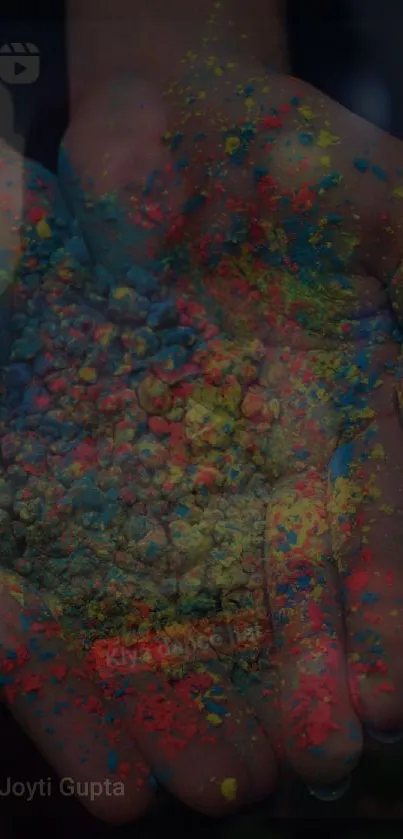 Hands holding vibrant colorful powder