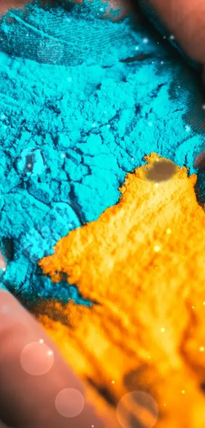 Colorful orange and blue powder in hand.