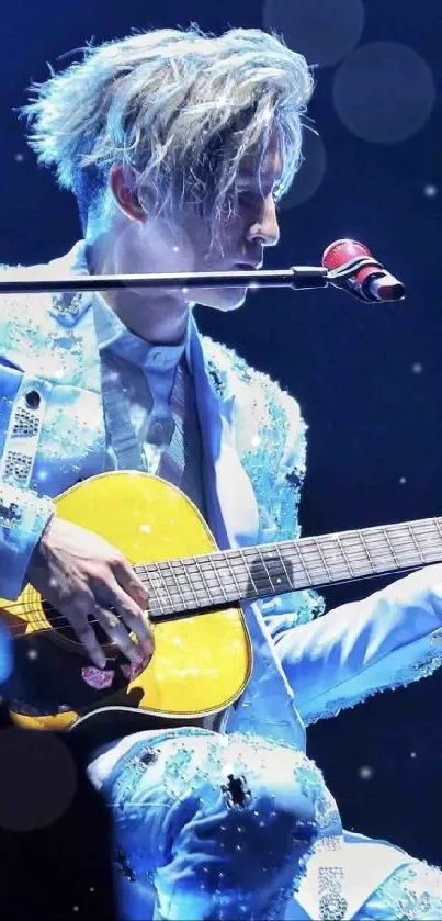 Musician on stage playing guitar with vibrant blue and yellow lighting.