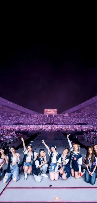 Crowded concert with performers on stage under dark sky.