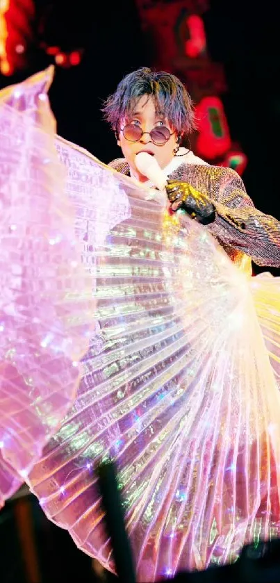 Performer in vibrant, illuminated outfit at concert.