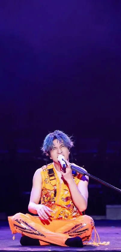 Performer in orange on stage with purple background.