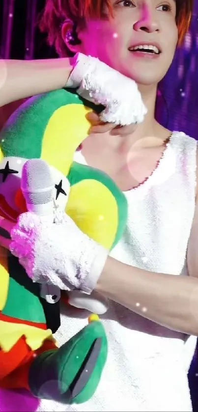 Colorful concert performer with plush toy on stage.