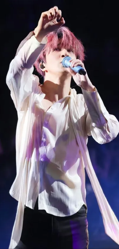 Dynamic performer singing passionately on stage with a microphone.