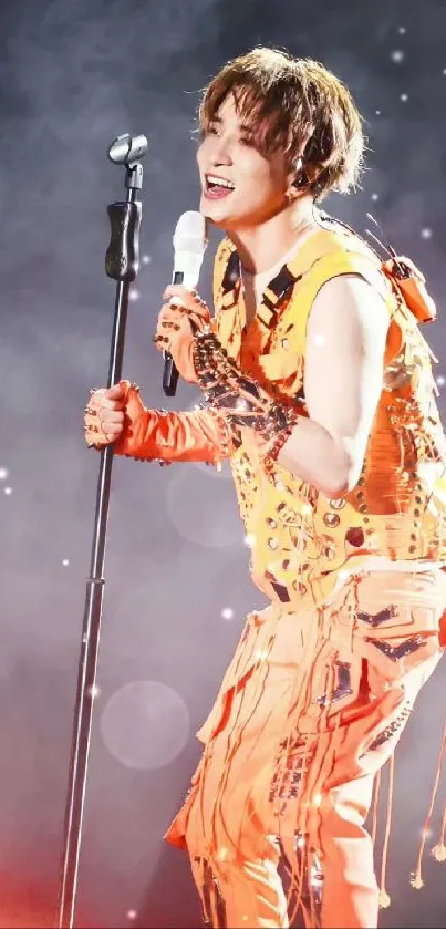 Vibrant performer in orange at a live concert.