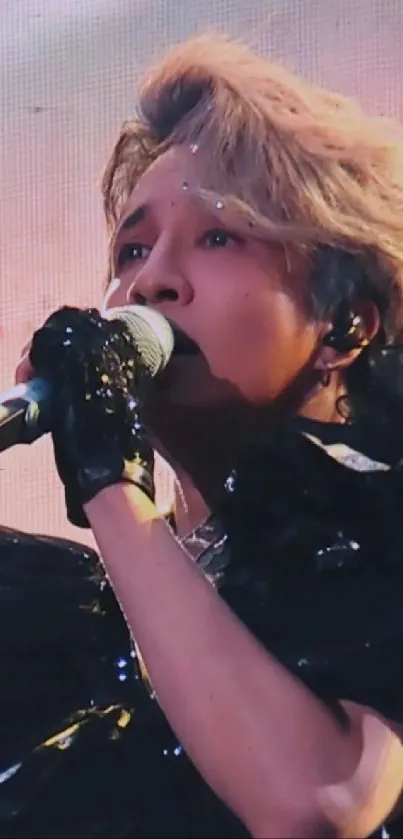 A passionate performer singing on a vibrant concert stage.