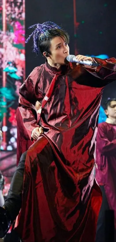 Energetic performer in red during vibrant concert.