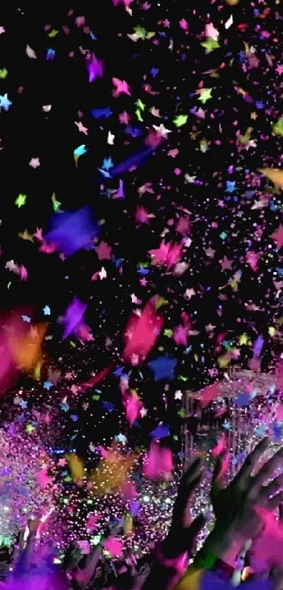 Vibrant confetti shower on a black background with hands reaching up.