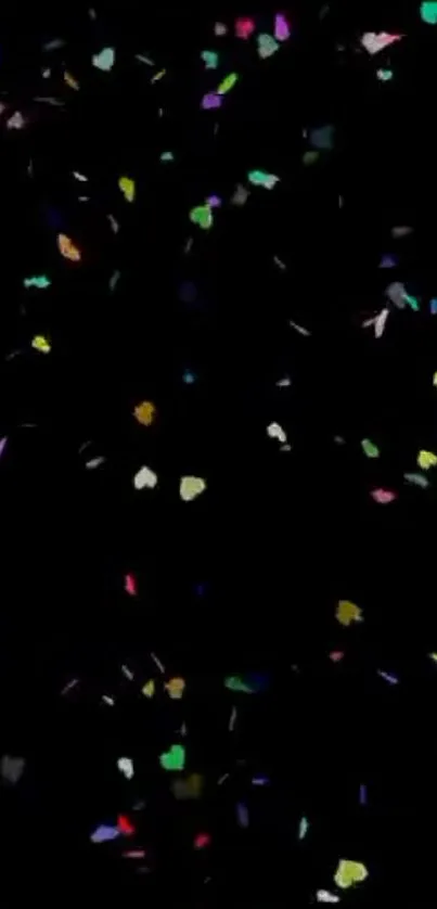 Colorful confetti specks on black background wallpaper for mobile.